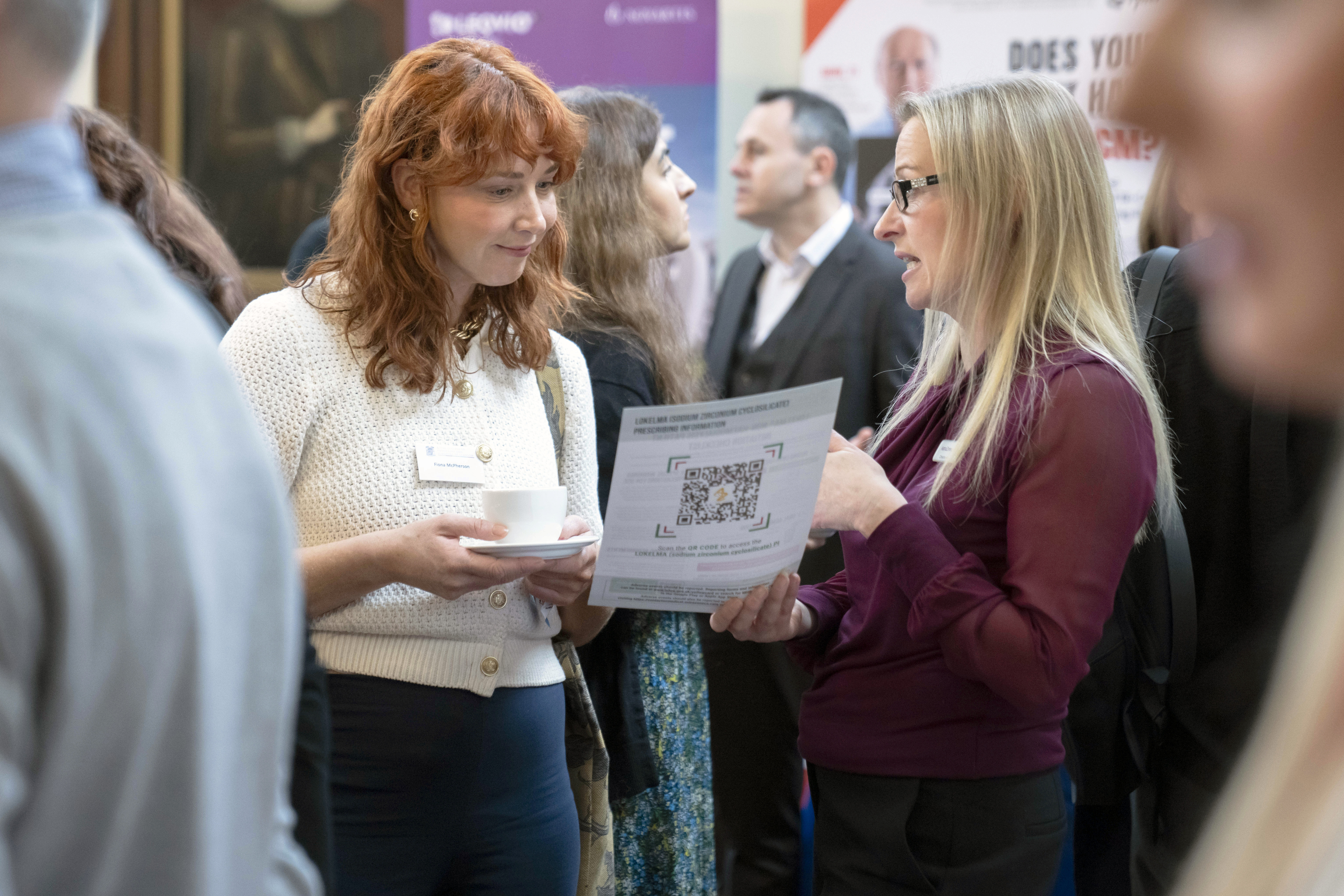 two people talking at the conference
